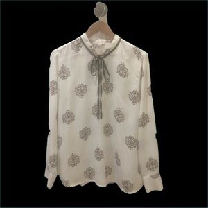 Lila Rose long sleeved blouse. White background with black/gold print. Size XL